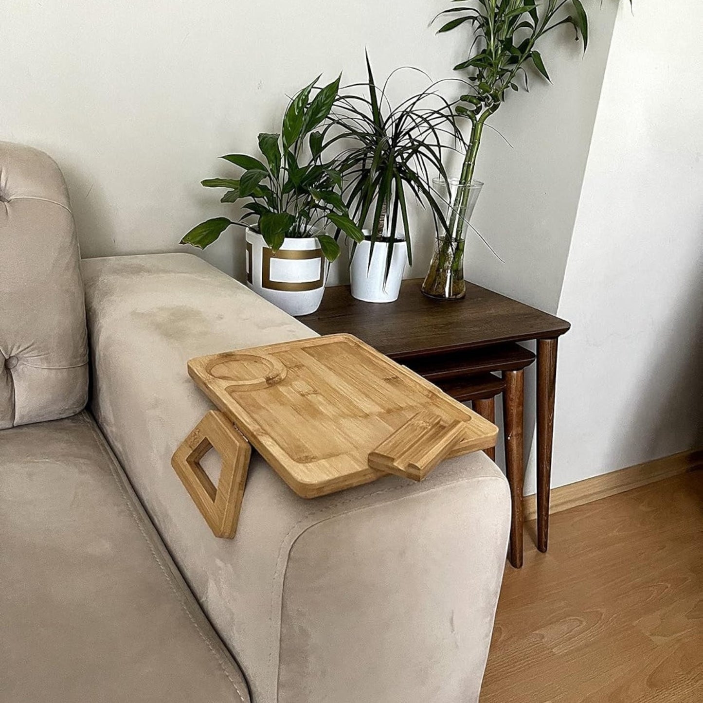 Khashba natural bamboo armrest tray table with cup holder and phone slot, drapes over sofa arm.